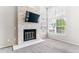 Living room featuring a stone fireplace, vaulted ceiling, and large windows at 1550 S Syracuse St, Denver, CO 80231