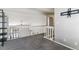 An open loft space with vaulted ceilings, neutral colors, and a view overlooking the lower level at 1550 S Syracuse St, Denver, CO 80231