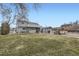 Large backyard featuring a covered outdoor bar area, spacious lawn, and a two-story home at 195 Briggs St, Erie, CO 80516