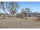 Gravel backyard featuring a covered outdoor bar area, a detached garage, and a fire pit at 195 Briggs St, Erie, CO 80516