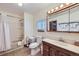 Functional bathroom with a shower-tub combo, wood vanity, and tile flooring at 195 Briggs St, Erie, CO 80516