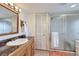 Bathroom featuring a single sink vanity with a stone-look counter, a shower with glass doors, and a closet at 195 Briggs St, Erie, CO 80516