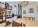 Inviting dining room with a tile-topped table, high ceilings, and views into the kitchen and living spaces at 195 Briggs St, Erie, CO 80516