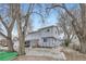 View of the home's front elevation and mature tree cover at 195 Briggs St, Erie, CO 80516