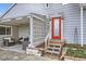 This home features a covered front porch with an eye-catching orange front door and lattice detail at 195 Briggs St, Erie, CO 80516