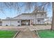 Charming front exterior featuring a red front door, covered porch and low maintenance yard at 195 Briggs St, Erie, CO 80516