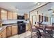 Cozy kitchen with oak cabinets, black appliances, and an adjacent dining area at 195 Briggs St, Erie, CO 80516