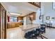 Bright kitchen with a breakfast bar, wood cabinets, tile floors, and natural light at 195 Briggs St, Erie, CO 80516
