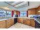 Functional kitchen featuring ample counter space, wood cabinetry, and views of the backyard at 195 Briggs St, Erie, CO 80516