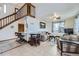 Spacious living room with a staircase and landing, a kitchen, and comfortable furniture at 195 Briggs St, Erie, CO 80516