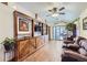 Bright living room with wood floors, built-in shelves, a ceiling fan, and sliding glass doors to the deck at 195 Briggs St, Erie, CO 80516