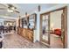 Open-concept living space with wood floors and a custom built-in entertainment center looking into a bedroom at 195 Briggs St, Erie, CO 80516