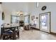 Living room with a glass top dining table, a seating area, and a doorway leading outside at 195 Briggs St, Erie, CO 80516