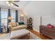 Bright bedroom with hardwood floors, a comfortable couch, and a decorative dresser at 471 S Grant St, Denver, CO 80209