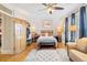 Spacious bedroom featuring hardwood floors, a cozy bed, and ample natural light at 471 S Grant St, Denver, CO 80209