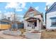 Charming Victorian-style home with colorful accents, inviting front porch, and landscaped front yard at 471 S Grant St, Denver, CO 80209