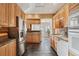 Well-appointed kitchen with stainless steel appliances, ample counter space, and natural wood cabinetry at 471 S Grant St, Denver, CO 80209