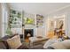 Comfortable living room featuring built-in bookshelves, a fireplace, and an adjacent dining area at 471 S Grant St, Denver, CO 80209