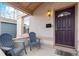 Inviting front porch with seating, a stylish entrance door, and charming architectural details at 471 S Grant St, Denver, CO 80209