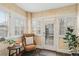 Bright sunroom with white trim, multiple windows, and a cozy seating area with tan leather chair at 471 S Grant St, Denver, CO 80209