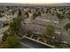 Picturesque aerial perspective of townhomes surrounded by lush greenery and distant mountain views, offering serene living at 7068 E Briarwood Dr, Centennial, CO 80112