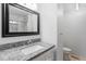Modern bathroom featuring a vanity, granite countertop, and elegant finishes at 7068 E Briarwood Dr, Centennial, CO 80112