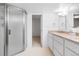Bathroom featuring a glass-enclosed shower, long vanity, and neutral tones at 7068 E Briarwood Dr, Centennial, CO 80112