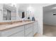 Bright bathroom features a dual sink vanity with granite counters and white cabinets at 7068 E Briarwood Dr, Centennial, CO 80112