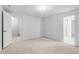 Spacious bedroom with neutral carpet, white walls, and multiple entryways at 7068 E Briarwood Dr, Centennial, CO 80112