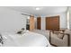 Inviting bedroom boasts a sliding barn door leading to the en-suite bathroom at 7068 E Briarwood Dr, Centennial, CO 80112