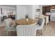 Dining area with round table, four upholstered chairs, and view into the living room at 7068 E Briarwood Dr, Centennial, CO 80112