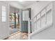 Entryway with open front door, stairs, and wood-look floors at 7068 E Briarwood Dr, Centennial, CO 80112