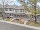 Attractive townhomes with neutral siding, brick accents, blue shutters, and inviting landscaping, offering comfortable living at 7068 E Briarwood Dr, Centennial, CO 80112