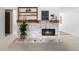 Close up on the living room fireplace featuring a custom mantel and brick hearth at 7068 E Briarwood Dr, Centennial, CO 80112