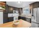 Modern kitchen featuring dark cabinets, stainless steel appliances, and light countertops at 7068 E Briarwood Dr, Centennial, CO 80112