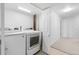Well-lit laundry room features new appliances and neutral flooring at 7068 E Briarwood Dr, Centennial, CO 80112