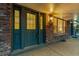 Inviting porch with brick detailing, a double entry door and exterior lighting at 7068 E Briarwood Dr, Centennial, CO 80112