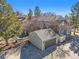 Aerial view of a gray townhome with a detached garage and mature landscaping on a sunny day at 909 Reynolds Farm Ln # C2, Longmont, CO 80503
