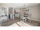 Contemporary dining area with seating for four, hanging light fixture, and view into modern kitchen at 909 Reynolds Farm Ln # C2, Longmont, CO 80503