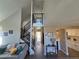 Staircase leading to the second floor with a view of kitchen and front door with lots of natural light at 909 Reynolds Farm Ln # C2, Longmont, CO 80503