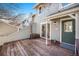 Townhome's back deck with a sliding glass door and welcome mat leading to home's entrance at 909 Reynolds Farm Ln # C2, Longmont, CO 80503