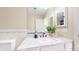 Bright bathroom featuring a modern vanity with a white countertop and decorative backsplash tiles at 9353 E 146Th Ave, Brighton, CO 80602