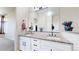 Elegant bathroom featuring double sinks, a large mirror, and granite countertops at 9353 E 146Th Ave, Brighton, CO 80602