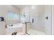 Elegant bathroom featuring a large mirror, a separate tub and tiled glass shower at 9353 E 146Th Ave, Brighton, CO 80602