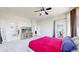 Bright bedroom features a ceiling fan, large windows, and an ensuite bathroom at 9353 E 146Th Ave, Brighton, CO 80602