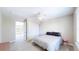 Bedroom features a ceiling fan, large windows, a closet, and a bed with a grey comforter at 9353 E 146Th Ave, Brighton, CO 80602