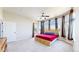 Bright bedroom features a ceiling fan, large windows, and a door to the outside deck at 9353 E 146Th Ave, Brighton, CO 80602