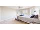 Bedroom features a ceiling fan, large windows, and a bed with a grey comforter at 9353 E 146Th Ave, Brighton, CO 80602