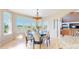 Bright breakfast nook with large windows and a lovely chandelier, perfect for morning meals at 9353 E 146Th Ave, Brighton, CO 80602