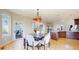 Charming breakfast nook featuring an elegant chandelier, light-filled space and a round dining table at 9353 E 146Th Ave, Brighton, CO 80602